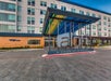 The entrance of an Aloft hotel with a large sign and covered driveway; the modern building exterior is visible in the background.