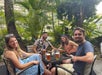 Four guests drinks beers outside