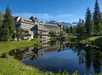 Refreshing resort exterior with mountain view and majestic lake.