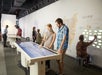 A man and woman interacting with the featured works tables in the Mind of a Writer gallery at the American Writers Museum.
