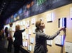 A woman interacting with the Surprise Bookshelf exhibit in the Nation of Writers gallery at the American Writers Museum.