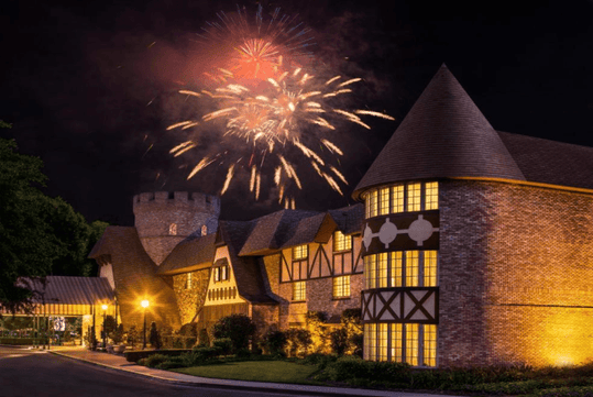 Hotel exterior with fireworks at night.