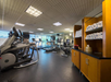 Fitness center with treadmills, elliptical trainers, and fresh towels.