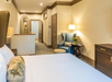 An upstairs bedroom with a king bed in a townhouse suite