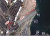A satellite view with arrows showing the path from a parking area to a check-in point on a marina dock; labels indicate "Parking," "Walk Down," and "Check-In HERE.