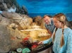 Two people experiencing the Tide Touch Pool in the Aquarium at the Boardwalk in Branson, Missouri.