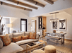 Living space with a fire pit, flat-screen TV, and soft seating inside a suite.