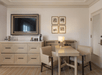 Flat-screen TV and a large desk inside a suite.