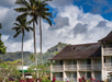 Beautiful landscaped hotel exterior surrounded with trees.
