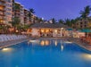 Serene outdoor pool with poolside chairs.