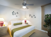 One bed and bedside lamp inside a guest room.