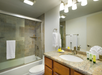 Private bathroom with bath tub  and sink.