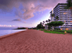 A beach at dusk with a high-rise building on the right, palm trees, and a purple sky.