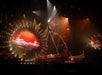 Performers on stage with a large wooden ship prop and a circular screen displaying a red sunset, under dramatic lighting effects.