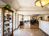 The lobby for the Baechtel Creek Inn with a lounge area and breakfast dining area in the background.