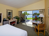 Guest room with one king bed, dining table, and patio with bay view.