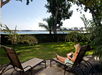 Private patio with lounge chairs and view of the bay.