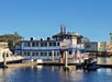 View of the side of the Barefoot Queen Riverboat parked at the dock on a sunny day in North Myrtle Beach.
