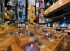 Exhibit hall featuring glass display cases with vintage shoes and hanging banners marked with decades from 1930 to 1990, showcasing historical fashion timelines.