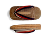 Two views of a traditional Japanese wooden sandal called geta, showing the top and side with thick woven straw and fabric straps.