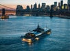 Bateaux Dinner Cruise on the East River with the lights of New York’s iconic skyline shining in the background.