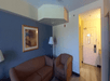Living area with a comfortable sofa inside a guest room.