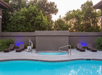 Outdoor pool with sun loungers.