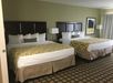 Two queen beds inside a guest room.