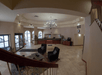 Wide shot of the lobby of the Baymont by Wyndham Shakopee with a seating area to the left of the entrance doors and the front desk to the right.