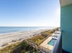 View of the beach and pool area from a guest room balcony.