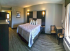 Guest room with one king bed, table, and chairs.
