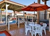 Covered hot tub and table and chairs with an umbrella.