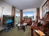 Living area with sofa bed and flat-screen TV at Best Western Naples Inn & Suites, FL.