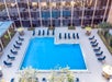 Outdoor pool with plenty of lounge chairs at Best Western Orlando Gateway.
