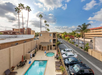 Outdoor pool and hot tub with pool lifts and sun loungers.