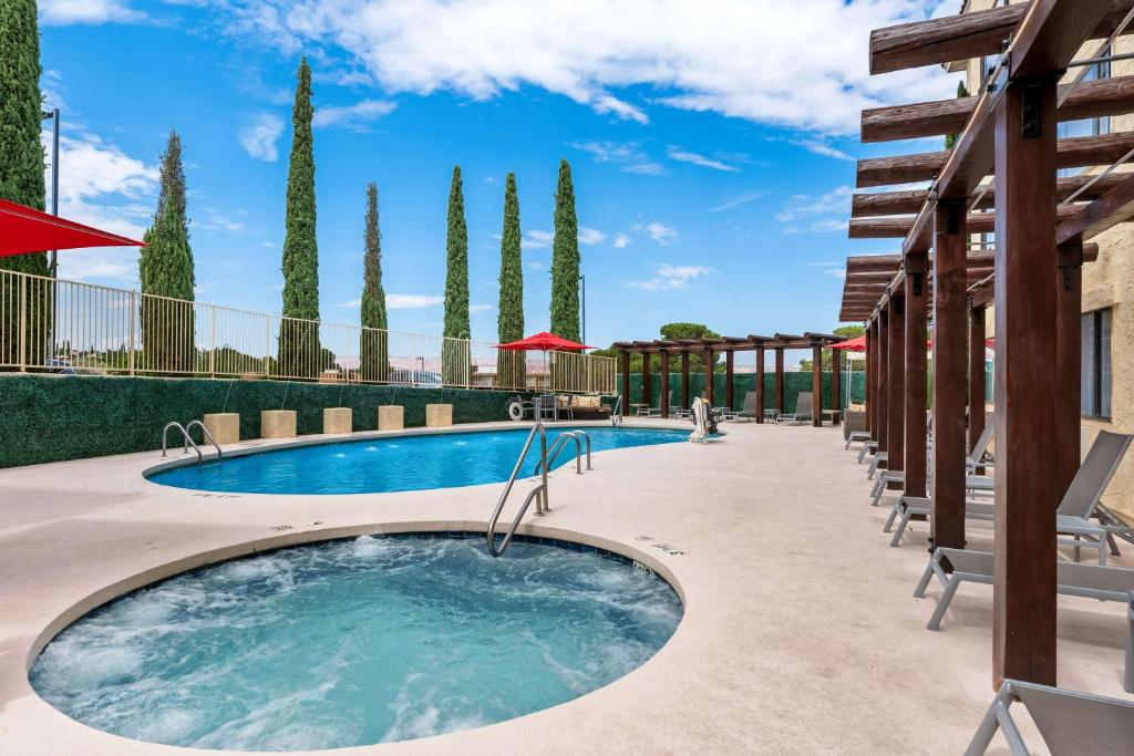Outdoor pool, hot tub and chairs and umbrellas for a perfect relaxing day.