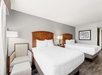 The room features two comfortable queen beds, perfect for a restful stay.