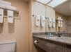 Fresh towels and complimentary toiletries inside a private bathroom.