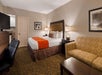 One king bed, a flat-screen TV, and a work desk inside a non-smoking room.