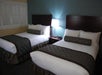 Two double beds inside a guest room.
