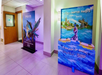 A hallway with two colorful Disney promotional displays, one for Pandora featuring a flying creature, and one for Disney’s Water Parks with Olaf on a blue water background.