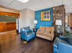 Relax in the cozy seating area, complete with a plush sofa.