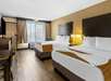 Enjoy comfort and convenience with two queen beds, a desk, and a flat-screen TV.