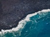 The cooled lava at the shore line seen from above on Big Island's Circle of Fire Helicopter Tour in Hawaii USA.