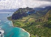 A helicopter flying along the coastline of Oahu with views of the mountains in the background on the Blue Skies of Oahu Helicopter Tour in Hawaii USA.