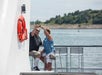 Guests taking a photo with the stunning background of Boston Harbor.