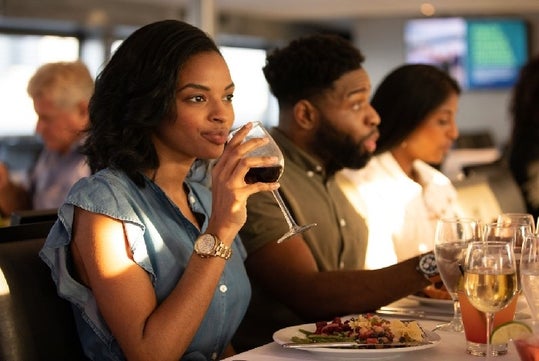 Guests drinking wine and enjoying their meal 