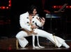 Bill Cherry in the white iconic Elvis costume performing on stage.