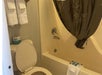 Guest bathroom with bathtub and shower combo. 