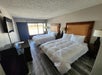 Two queen beds, a seating area, flat-screen TV inside a Double Queen Room.